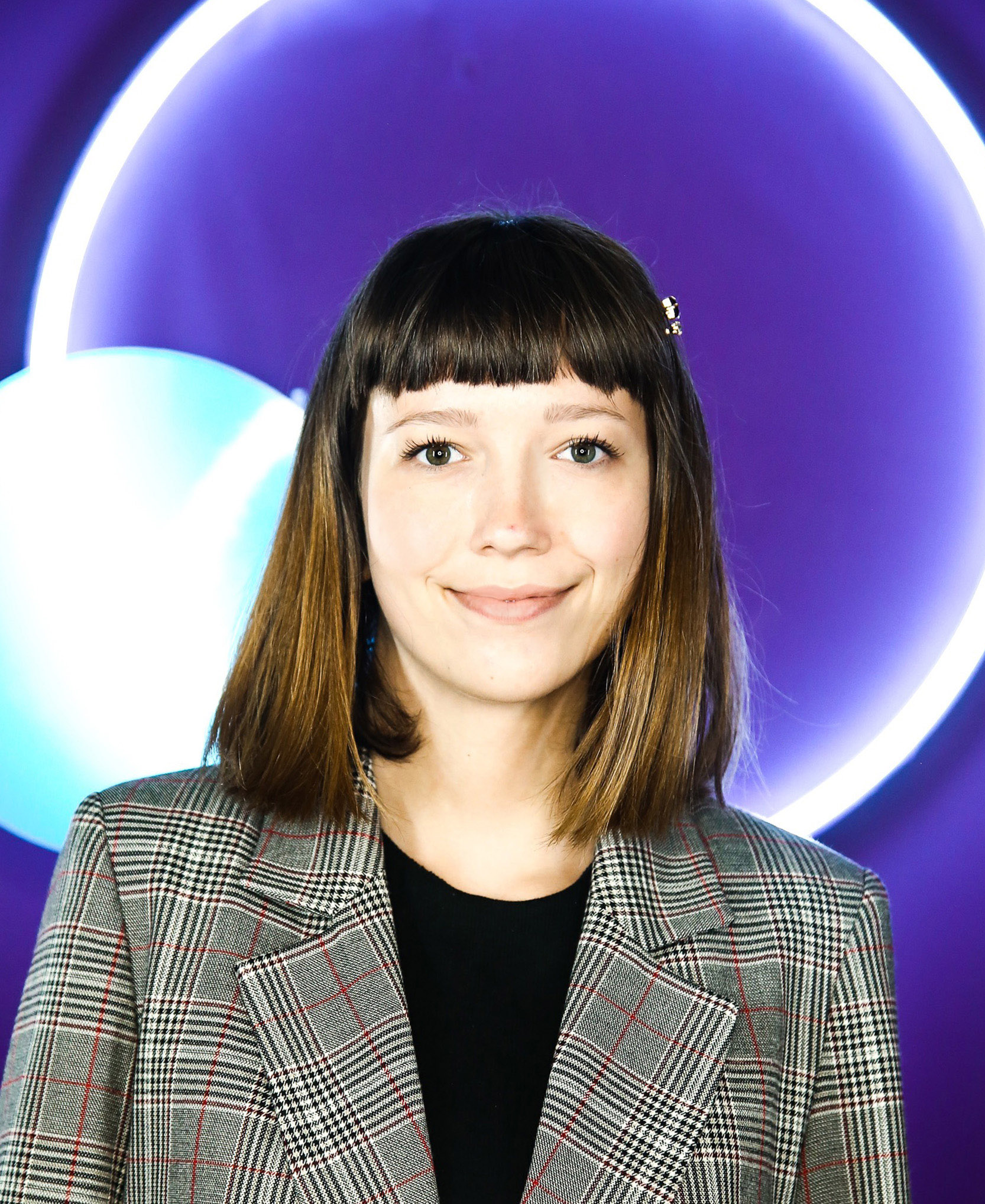 picture of marlowe in a suit with a purple background